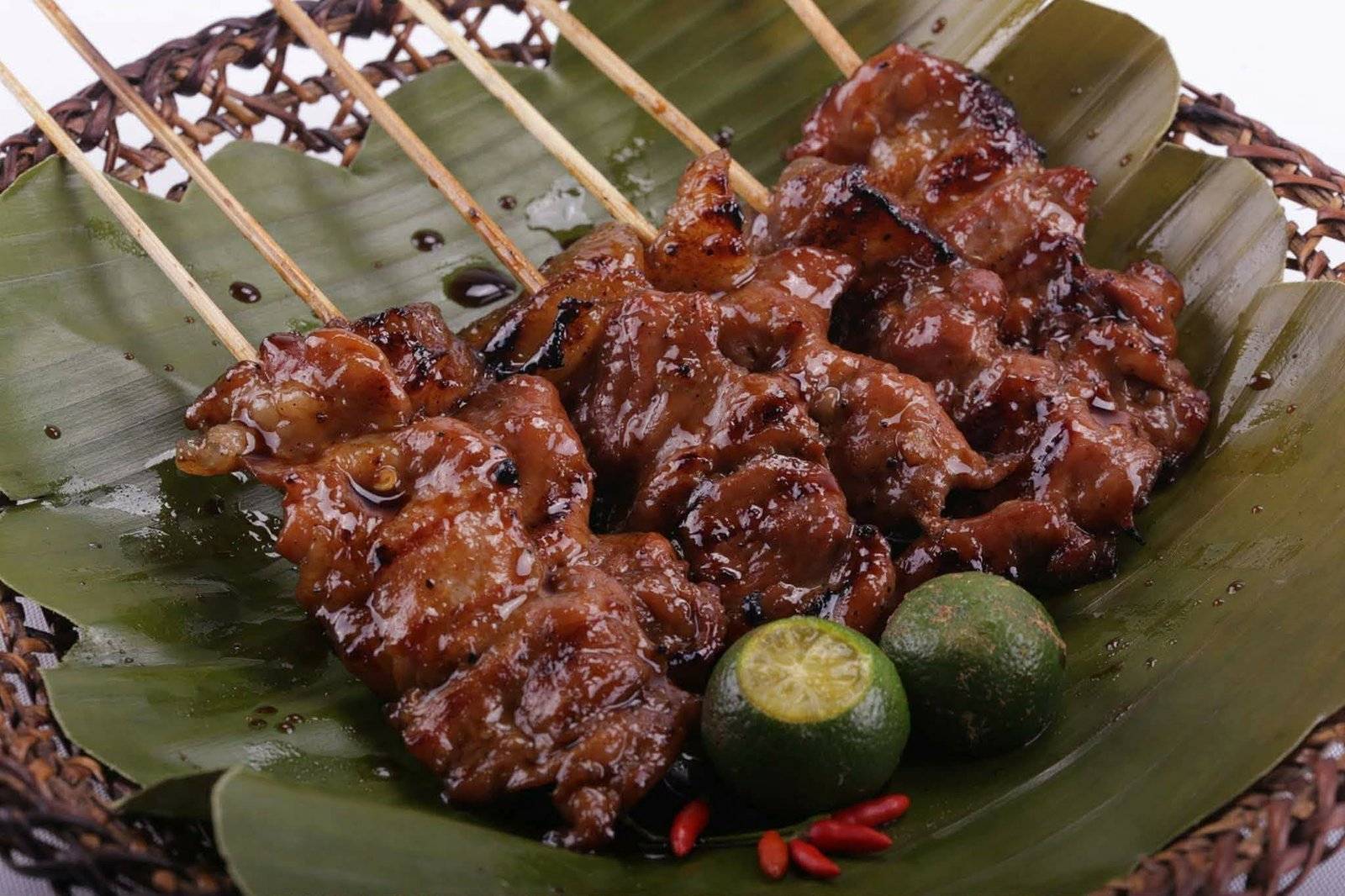 Close-up of glazed charcoal-grilled pork barbecue with calamansi and chili